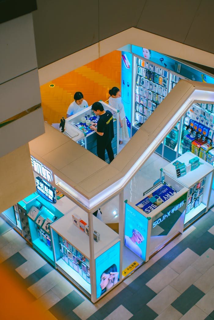 Aerial view of people browsing an electronics store in a shopping mall.